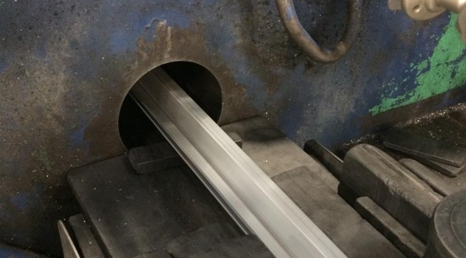 This photo shows an extrusion exiting the front of the press